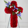 Red floral cross on a stand with blue and white accents