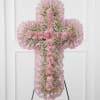 Pink floral cross-shaped standing spray on an easel
