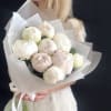 Bouquet of white peonies wrapped in translucent paper