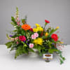 Colorful mixed flower arrangement in a white pedestal vase