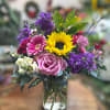 Bright, colorful, cheerful. A fun mix of seasonal blooms in a recycled