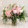 Pink and white floral arrangement in a clear glass vase