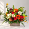 Colorful mixed flower arrangement in a textured rectangular vase
