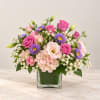 Pink and purple mixed bouquet in a clear glass vase