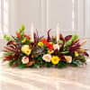 Low floral centerpiece with candles, roses, succulents, and autumn blooms