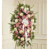 Standing floral spray with pink and white flowers and a white ribbon