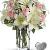 Pink roses and white lilies in a clear glass vase