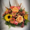 Arranged in dish in autumn colored flowers, this round centerpiece measures about