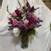 Pink and purple mixed bouquet in a clear glass vase
