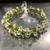 White floral wreath with a sheer ribbon bow