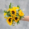 Bright and beautiful sunflowers mixed with delicate greenery and white accented flowers.