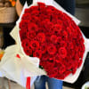 Large bouquet of red roses wrapped in white paper