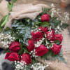 Bouquet of red roses with baby's breath wrapped in burlap