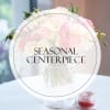 Pink and white flower centerpiece in a clear glass vase