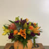 A vibrant seasonal selection presented in a classic orange pumpkin. Flowers include