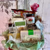 Gift basket with assorted packaged foods and a pink rose