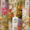 White reed diffuser bottle with floral packaging and colorful flowers