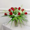 Red roses and white orchids in a clear glass vase
