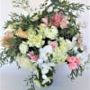 Tall arrangement with lush of seasonal flowers and orchids, matching harmoius colors.