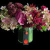 Mixed bouquet of burgundy and pink flowers in a glass vase