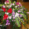 Mixed bouquet with red anthuriums, pink roses, and purple orchids