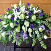 Large white and purple floral spray with cascading greenery