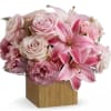 Pink roses and lilies arranged in a square wooden vase