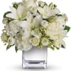 White lilies and roses arranged in a clear glass vase