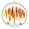 Metal wall hanging with hanging leaf shapes in autumn colors