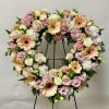 Heart-shaped floral wreath with pink, cream, and peach flowers