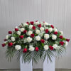 This Casket Spray Includes Red Roses, White Carnations and Babies Breath. Or
