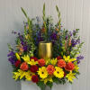 This Urn Wreath Includes Orange Gladiola, Purple Stock, Yellow Snapdragon, Blue Delphinium