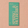Green chocolate bar package on a pink textured background