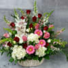 Basket arrangement of red and pink roses with white orchids and daisies