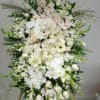 Large white floral standing arrangement with orchids and lilies