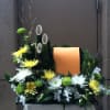 Floral arrangement with yellow and white chrysanthemums around an orange panel