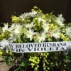 Simple yet elegant arrangement of white chrysanthemums and green orchids 