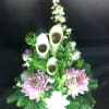 Floral arrangement with pink chrysanthemums, white daisies, and bamboo stems