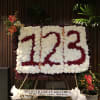 Statement numeric wreath made of white and red fancy carnations, accented with