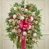 Standing floral spray with pink and white flowers and a bright pink ribbon