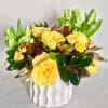 Yellow roses and green tulips in a white vase