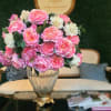 Pink and white flower arrangement in a glass vase