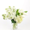 White flowers arranged in a clear glass vase