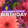 Bright mixed bouquet with a large pink gerbera and purple iris, overlaid with birthday text
