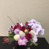 An elegant mix of roses and tulips embraced by beautiful orchids and