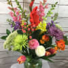A colorful combination of spring flowers such as tulips,ranunculus,hypericum berries,gladiola,snap dragons,spider mums