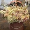 An elegant flower arrangement designed with white and pastel pink colors for