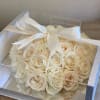 Elegant white playa blanca roses in the shape of heart enclosed in