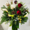 Tall holiday arrangement with red roses, white blooms, calla lilies, evergreens, pinecones and gold ornaments in a green vase