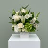 A mixed bouquet of green and white flowers to include white lilies